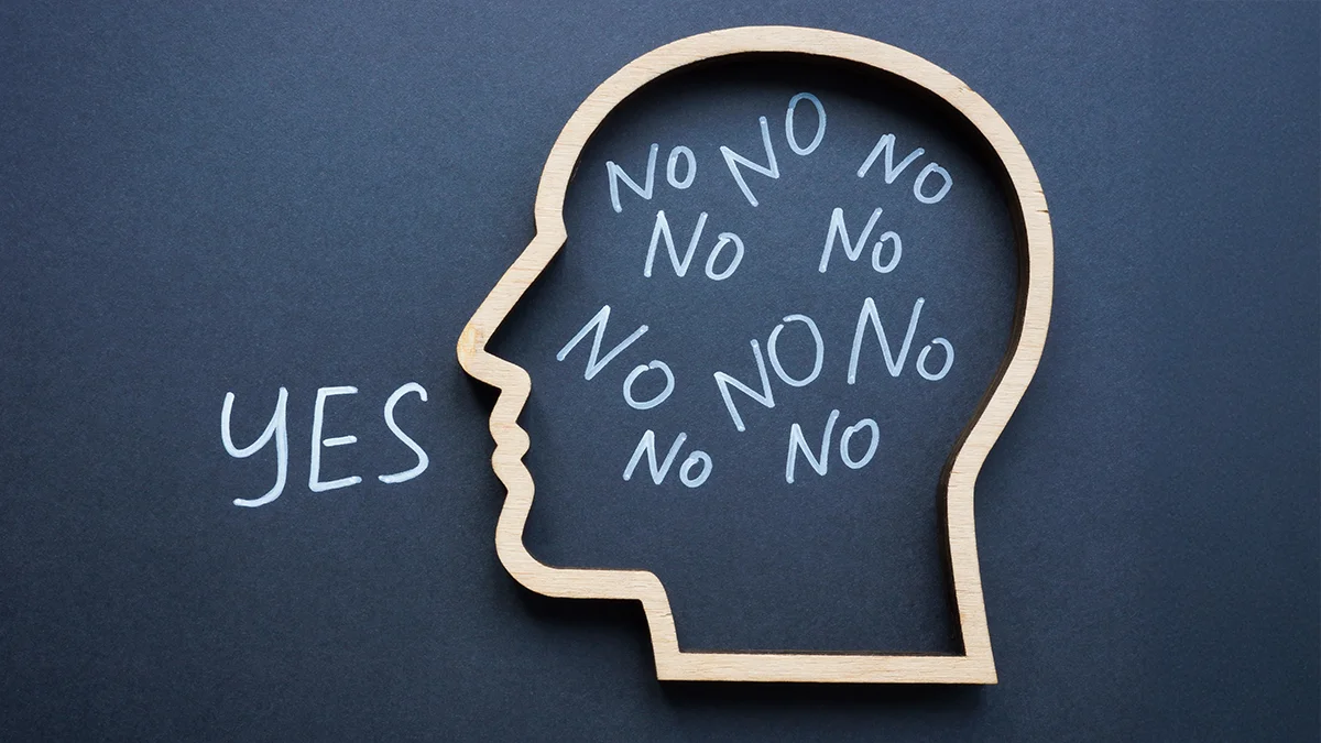 A head outline on the blackboard with the words "no" floating inside the head, and "yes" coming out of the mouth